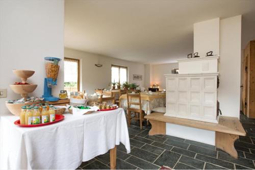 a kitchen with two tables with food on it at B&B Cecilia in Valfurva