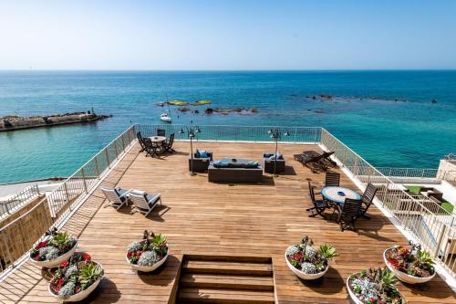 a deck with a view of the ocean at Casa Nova - Luxury Suites & Boutique Apart-Hotel in Tel Aviv
