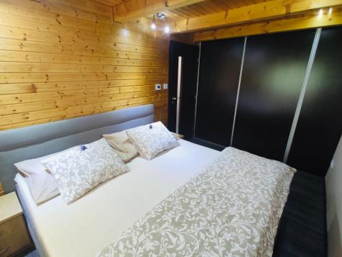 a bedroom with a white bed with two pillows at Grand Spa Holiday Home in Sklené Teplice