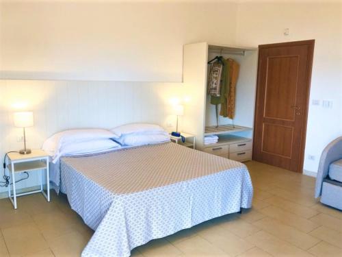a bedroom with a bed and a table and a mirror at Hotel Villa Eleonora in Scauri
