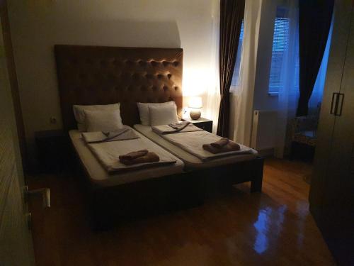 a bedroom with a bed with two towels on it at Family Apartments in Zaječar