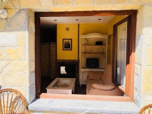 a living room with a couch and a fireplace at Apartamentos La Guergola in Pola de Somiedo