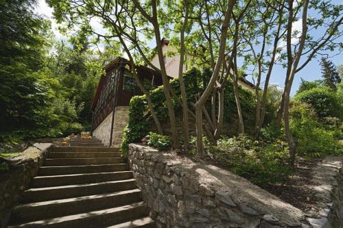 a set of stairs next to a stone wall at Penzion Onyx in Český Krumlov