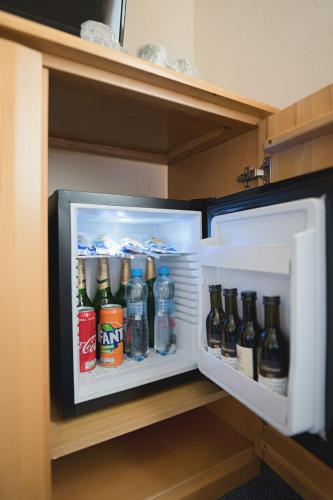 a refrigerator filled with lots of different types of drinks at Penzion Onyx in Český Krumlov