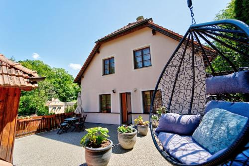 a porch swing in front of a house at Penzion Onyx in Český Krumlov