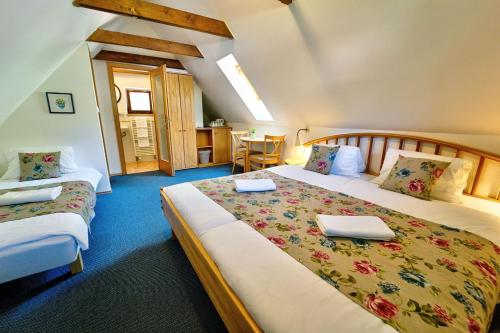 a hotel room with two beds with laptops on them at Penzion Onyx in Český Krumlov