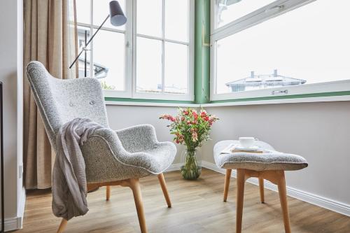 a living room with a chair and a table at Villa Fortuna in Ostseebad Sellin