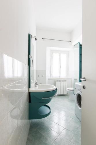 a bathroom with a toilet and a washing machine at La casa del tenore in Recanati