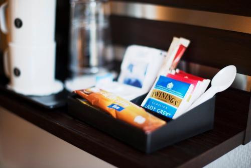 a shelf with a box of food and a spoon at Havly Hotell in Stavanger