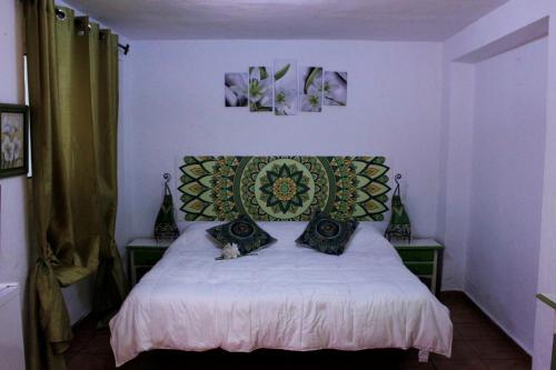 a bedroom with a bed with two pillows on it at H Juan in Marbella