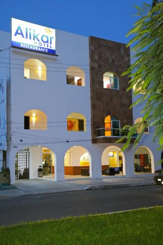 a large white building with a sign on it at Hotel Alikar in Santa Cruz Huatulco