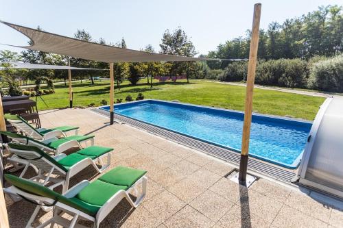 a patio with chairs and a swimming pool at Penzion Platan in Ňárad