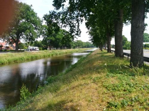 a river with trees on the side of a road at Haus konni in Haren