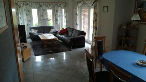 a living room with a couch and a table at Haus konni in Haren