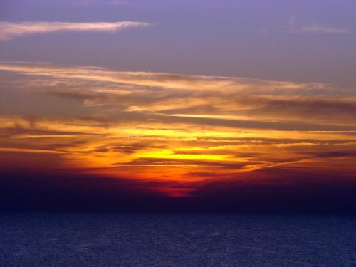 an image of a sunset in the sky at Butas Nida Ramybė in Nida