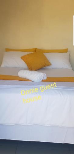 a bed with white sheets and pillows on it at ONNIE GUESTHOUSE in Louis Trichardt