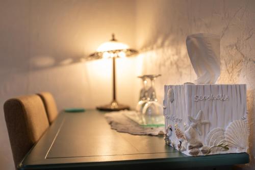 a table with a lamp and a box on it at Prince Street Suites in Charlottetown