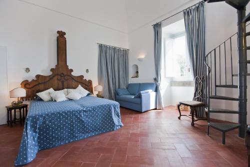 a bedroom with a blue bed and a blue couch at Villa Stella in Massa Lubrense