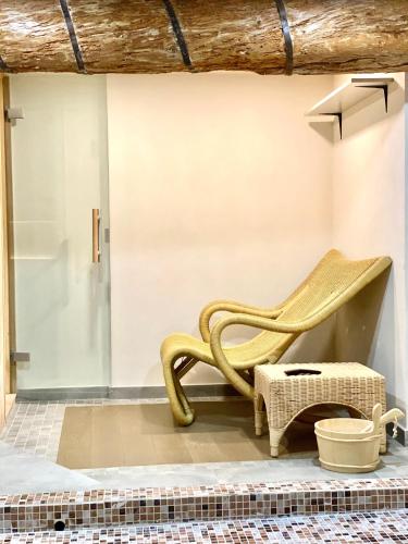 a wooden chair sitting on a floor next to a wall at ABCdecor Italia in Imperia