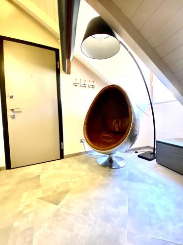 a large metal chair in a room with a door at ABCdecor Italia in Imperia