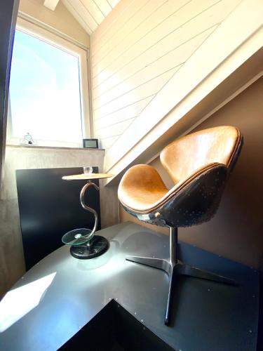 a chair sitting on a desk under a window at ABCdecor Italia in Imperia