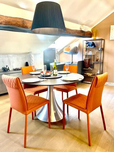 a dining room with a table and four chairs at ABCdecor Italia in Imperia