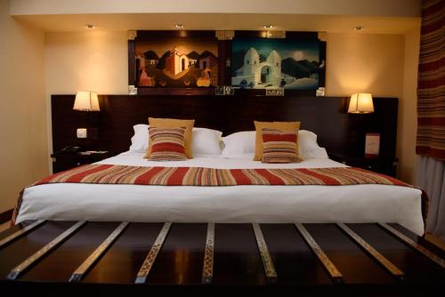 a bedroom with a large bed with two pillows at Hotel Alejandro I - Affiliated by Meliá in Salta