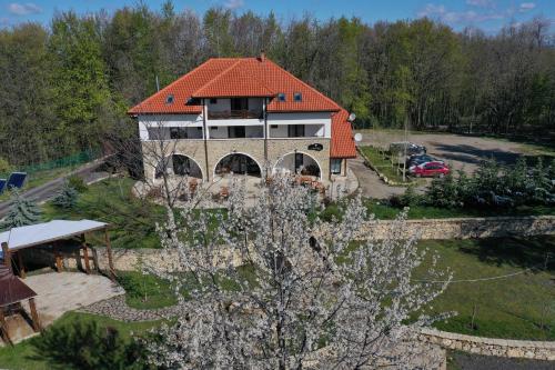 an aerial view of a house with a red roof at Cetatuia in Măgura