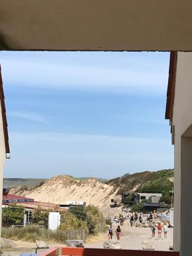 a group of people standing on the beach at Studio à Wissant avec vue sur Mer in Wissant