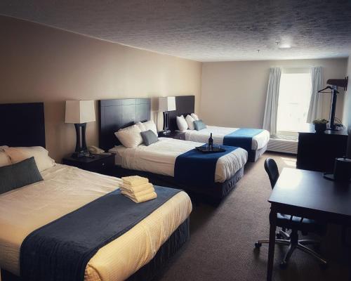 a hotel room with two beds and a desk at Bay Lodging Resort in Put-in-Bay