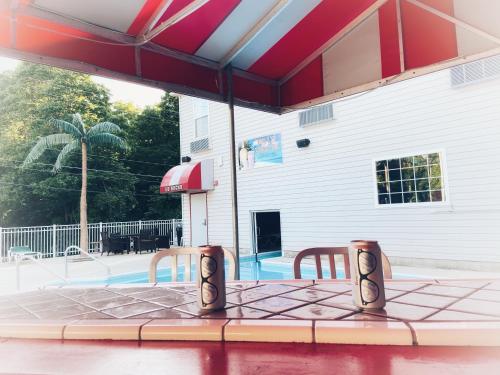 a patio table with two chairs in front of a pool at Bay Lodging Resort in Put-in-Bay