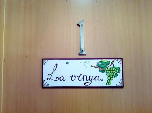 a sign on a wall with a sign for a wine sign at Can Panxeta in Pallaresos