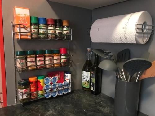 a organized pantry with spices and a roll of paper towels at Apartments Braunschweig - Noahs Home - Balkon - Küche - Parkplatz in Braunschweig