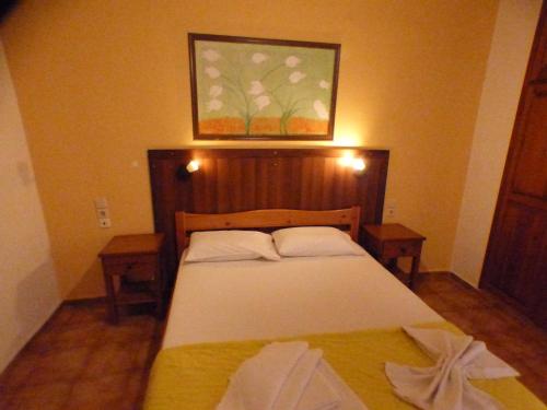 a bedroom with a bed and a picture on the wall at Eleni Apartments in Hersonissos