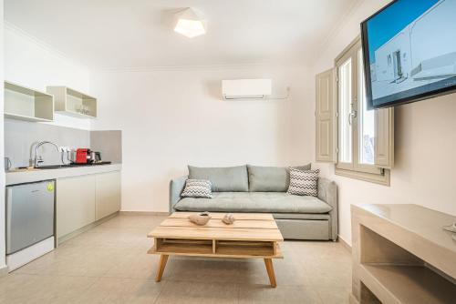 a living room with a couch and a table at Caldera Stories private suites in Megalokhori