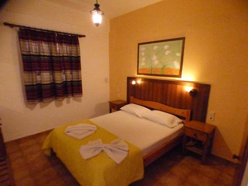 a bedroom with a bed with two towels on it at Eleni Apartments in Hersonissos