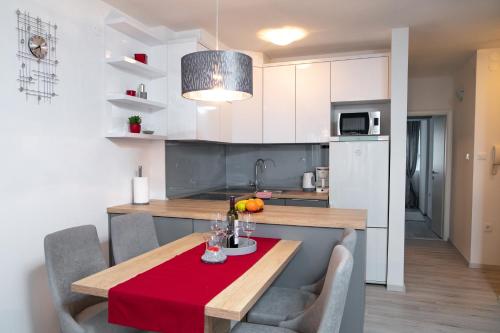 a kitchen with a table with a red table cloth at Dimani in Split