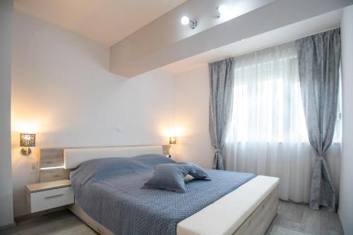 a bedroom with a bed and a window at Dimani in Split
