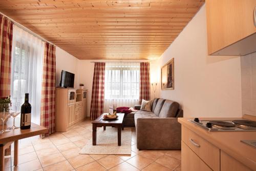 a living room with a couch and a table at Hotel-Gasthof Der Wiesengrund in Bad Hindelang