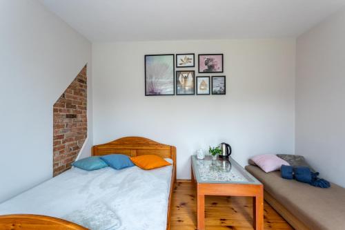 a bedroom with two beds and a table at Agroturystyka Lubaczówka in Sarbinowo