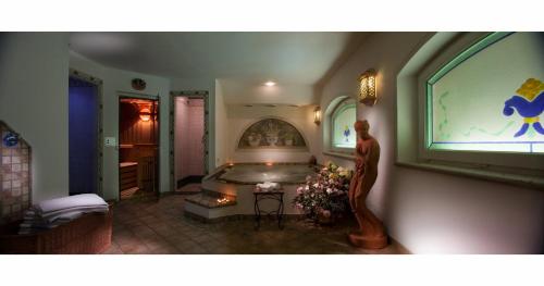 a bedroom with a large tub in a room at Hotel Miralago Wellness - Adults Only in Molveno