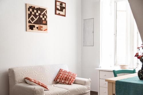 a living room with a couch and a table at B&B LE TRE CHIOCCIOLE in SantʼAntìoco