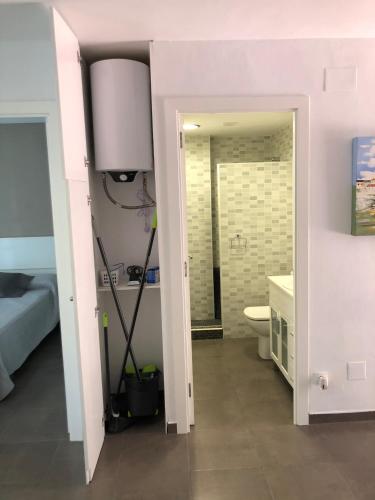 a room with a bathroom with a toilet and a sink at Apartaments Colibri in Cambrils