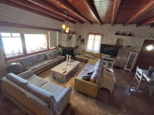 a large living room with couches and a fireplace at Sun Holiday House in Pisses