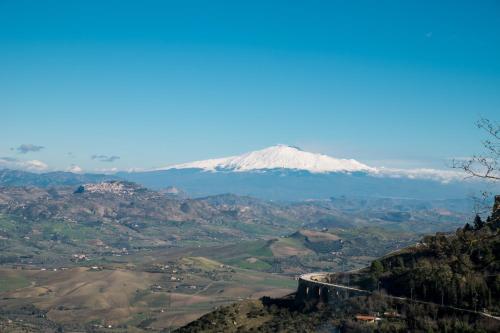 a view of a snow covered mountain in the distance at Una Casa al Belvedere in Enna