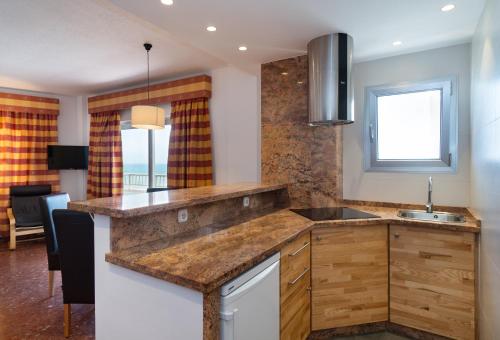a kitchen with a counter top and a sink at Hotel Apartamentos Bajondillo in Torremolinos