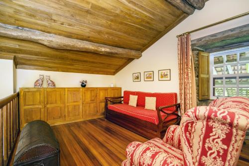 a living room with a couch and a chair at Quinta de Santa Júlia in Peso da Régua