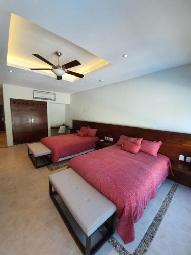 a bedroom with two beds and a ceiling at LYDMAR BOUTIQUE HOTEL in Zihuatanejo