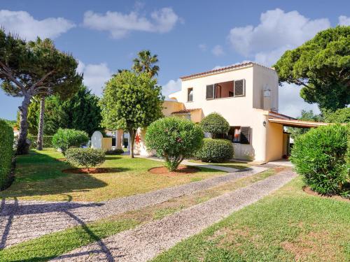 a house with a garden in front of it at Modern villa in an exclusive residential area with a private swimming pool in Vilamoura
