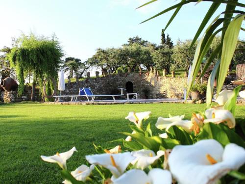 a park with a table and flowers in the grass at Charming Escape in Modigliana in Modigliana